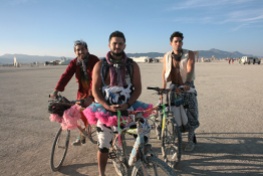 3 men on bikes at burning man in tutu's